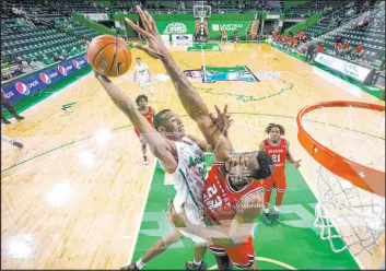  ?? Sholten Singer The Herald-dispatch via AP ?? Marshall’s Taevion Kinsey tries to dunk over Western Kentucky’s Charles Bassey during a Jan. 17 Conference USA game last season in Huntington, W. Va.