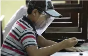  ?? TATAN SYUFLANA AP ?? A student wearing a face at the Nurul Amal Islamic school in Tangerang, Indonesia, on Nov. 23.