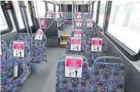  ?? STEPHEN M. DOWELL/ORLANDO SENTINEL ?? Signs encouragin­g social distancing are placed on the seats of a bus Friday at the Lynx central station in downtown Orlando.