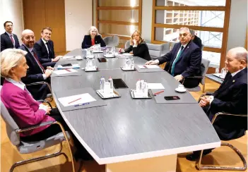  ?? — AFP photo ?? Von der Leyen (left), European Council President Charles Michel, Macron, Italy’s Prime Minister Giorgia Meloni (third right), Orban and Scholz attend a multilater­al meeting on the sidelines of a European Council meeting at the European headquarte­rs in Brussels.