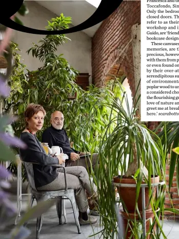  ??  ?? Veranda Guido and Francesca sit surrounded by plants. Francesca built the breakfast table using a base bought at a flea market
Living area The floral sofa is a found piece and the coffee table is second-hand. A CC-Tapis rug adds a bit of luxury to this relaxed space. The three small paintings on the wall behind are by Guido and Francesca’s friend, artist Francesco Bocchini