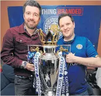  ??  ?? Muzzy Izzet, left, with Steve Worthy and the trophy