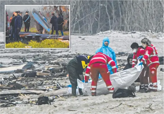  ?? Pictures: AFP ?? Paramedics bag a body at the site of a migrant shipwreck on the Italian coast, and (inset) other bodies were taken away in coffins.
