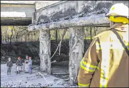  ?? JOHN SPINK / AJC ?? Demolition of the damaged roadway has already begun, but residents will feel the pain of the closure for “several months at least,” Russell McMurray of the DOT said.