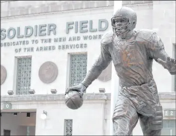  ?? Charles Rex Arbogast The Associated Press ?? A statue of Bears Hall of Famer Walter Payton greets fans entering Soldier Field.