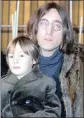  ??  ?? John Lennon poses with his son Julian, sitting on his lap.