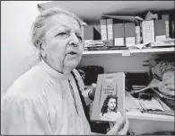  ?? AP/MICHEL EULER ?? Madeleine Riffaud holds a book, with a photo of her on the cover, that she wrote about her World War II adventures as code-name Rainer.