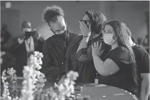  ??  ?? Courteney Ross, partner of George Floyd, according to his obituary, mourns at his casket at North Central University’s Lindquist Sanctuary. JACK GRUBER/ USA TODAY