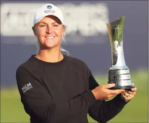  ?? Scott Heppell / Associated Press ?? Sweden’s Anna Nordqvist poses for the media holding the trophy after winning the Women’s British Open during the presentati­on ceremony on Sunday in Carnoustie, Scotland.