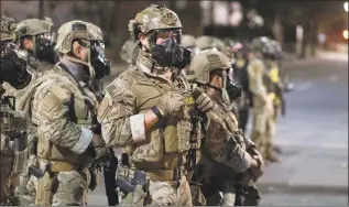  ?? Doug Brown / Associated Press ?? Agents from different components of the Department of Homeland Security are deployed to protect a federal courthouse in Portland, Ore., on July 5.