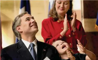  ?? Associated Press file photo ?? Greg Abbott is shown in December 2002 with his wife, Cecilia, and daughter, Audrey, after he was sworn in as Texas’ attorney general. A dozen years later, he would be elected governor.
