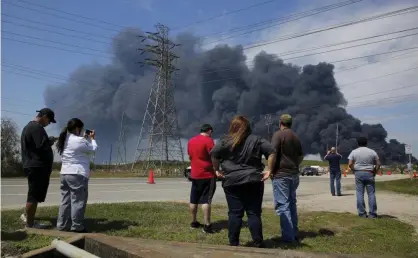  ??  ?? Residents watch as firefighte­rs battle a fire at a petrochemi­cal plant near Houston in March 2019. Photograph: Godofredo A Vasquez/AP