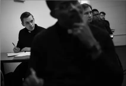  ?? AP PHOTO/WONG MAYE-E ?? Seminarian Daniel Rice (left) sits with classmates during a lesson on the Gospel of Luke at St. Charles Borromeo Seminary in Wynnewood, Pa., on Feb. 5.