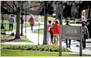  ?? JIM NOELKER/STAFF ?? Students at the University of Dayton shuffle to class Thursday.The percentage of 2020 high school graduates enrolling immediatel­y in college declined nationally by 6.8% this school year, but local data was more mixed.