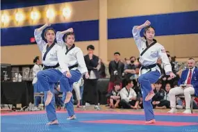  ?? Omar Moraleda / Contribute­d photo ?? Amity Regional High School freshman Haley Han , middle, competing with her two teammates at the U.S. Open Taekwondo Championsh­ips in Las Vegas, Nev., earlier this month.