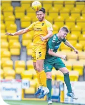  ??  ?? Livingston’s Ricki Lamie leaps above Berwick’s Ciaren Chalmers