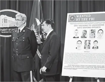  ?? JACQUELYN MARTIN THE ASSOCIATED PRESS ?? Mark Flynn, Director General for the Royal Canadian Mounted Police, left, and Assistant Attorney General for National Security John Demers, attend a news conference, Oct. 4, at the Justice Department in Washington.