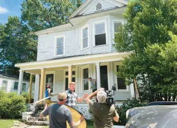  ?? ?? “This Old House” host Kevin O’Connor prepares to install the front door on a five-bedroom Victorian house Aug. 10 near Atlanta.