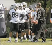  ?? Michael Macor / The Chronicle ?? Wide receivers, including Amari Cooper ( 89), get instructio­ns at the Raiders’ rookie minicamp.