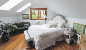  ??  ?? A formerly dark master bedroom with steeply sloping walls, is now much brighter after LeBlanc's son painted it white and added two skylights.