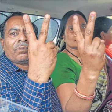  ?? PTI ?? The mother and father of the woman who was gang-raped on December 16,2012, flash the victory sign as they leave Patiala House court in n
New Delhi on Thursday. The court had dismissed the plea of three death-row convicts seeking a stay on their execution.