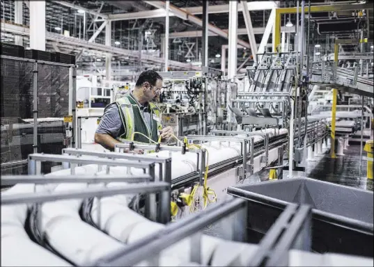  ?? Joel Angel Juarez Las Vegas Review-Journal @jajuarezph­oto ?? Plant manager Sean Krajnik inspects cut rolls of tissue paper Aug. 31 at the Clearwater Paper plant in North Las Vegas.