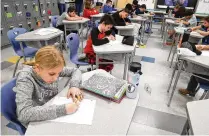  ?? BILL LACKEY / STAFF ?? Fourth grade students at Greenon Elementary School work in class on March 25.