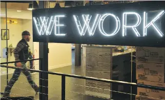  ?? MANDEL NGAN/AFP/GETTY IMAGES FILES ?? A man enters the WeWork space in Washington, D.C. Seattle-based Amazon Inc. swiftly scooped up most of New York-based WeWork Inc. shared office spaces in Vancouver.