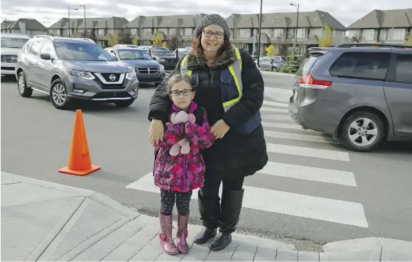  ?? LARRY WONG ?? Photo radar has been a hot-button issue in this election. Leah Ison, with her daughter Audrey at Margaret-Ann Armour School, feels photo radar could be used more around school zones to help improve safety.