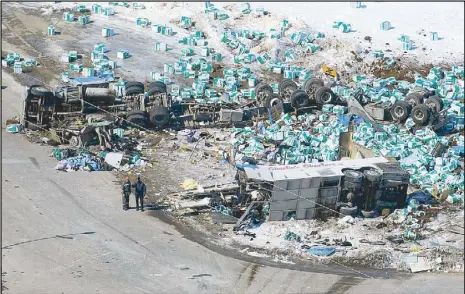  ?? AP ?? Emergency personnel work at the scene of a bus and truck collision in Canada on Saturday.