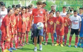  ??  ?? England U17 player Jadon Sancho displays skills to kids at Newtown School in Kolkata.