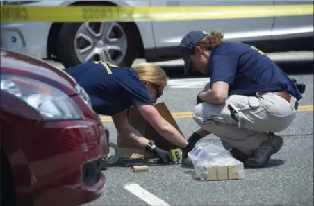  ?? CLIFF OWEN — THE ASSOCIATED PRESS ?? FBI Evidence Response Team members mark evidence at the scene of a multiple shooting in Alexandria, Va., Wednesday involving House Majority Whip Steve Scalise of La., and others during a congressio­nal baseball practice.