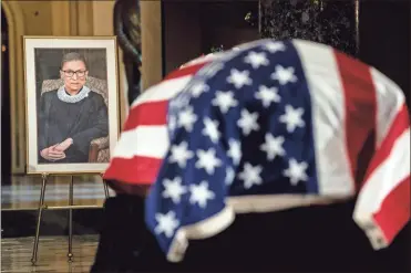  ?? Ap-erin schaff ?? The flag-draped casket of Justice Ruth Bader Ginsburg lies in state in the U.S. Capitol on Friday. Ginsburg died at the age of 87 on Sept. 18 and is the first women to lie in state at the Capitol.