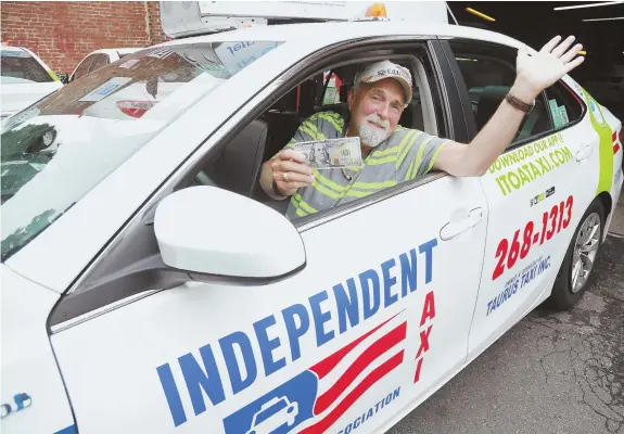  ?? STAFF PHOTO, ABOVE, BY MATT WEST; PHOTO, TOP, COURTESY OF BPD NEWS ?? CASH AND CARRY: Raymond MacCauslan­d, 72, an Independen­t Taxi Operator’s Associatio­n driver, found over $187,000, top, in his cab and turned it in to police. MacCauslan­d is seen holding the $100 reward he received for turning in the money.