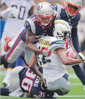  ?? John Cetrino European Pressphoto Agency ?? TRAVIS BENJAMIN, tackled by the Patriots for a safety, made the Chargers’ biggest goof of the game as he dropped a punt at the 11, recovered it at the eight, reversed field and retreated into the end zone.