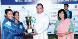  ??  ?? The Captains of Lyceum Wattala Rashmi Geekanda and Sayuni Mendis receiving the overall challenge trophy from the Minister of Sports Dayasiri Jayasekera, PIC BY DAMITH WICKREMASI­NGHE