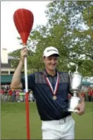  ?? AP Photo ?? Justin Rose poses with the trophy and a wicker basket after winning the U.S. Open Sunday at Merion.