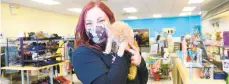  ?? SHORTELL / THE MORNING CALL AMY ?? Nine Lives thrift shop is now open in Coopersbur­g and supports local cat rescues. Owner Samantha Malone, holding a kitten, is currently supporting A Bigger Purpose Kitten Rescue of Hellertown.