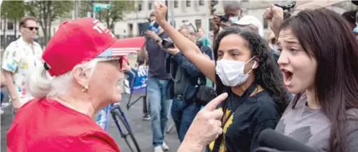  ?? ASHLEE REZIN GARCIA/SUN-TIMES ?? A supporter of President Donald Trump argues with Black Lives Matter protesters Tuesday outside of the Kenosha County Courthouse.