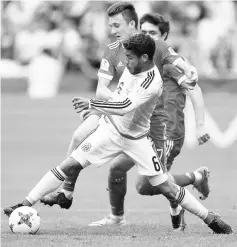  ??  ?? Mexico’s Jonathan dos Santos (front) in action with Russia’s Aleksandr Golovin during the Confederat­ions Cup group A football match at the Kazan Arena Stadium in Kazan in this June 24 file photo. — Reuters photo