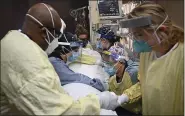  ?? AARON LAVINSKY — THE ASSOCIATED PRESS ?? Critical care nurses and respirator­y therapists flip a patient with COVID-19 upright at North Memorial Health Hospital in Robbinsdal­e, Minn., Dec. 7. Virtually every state is reporting surges in cases and deaths.