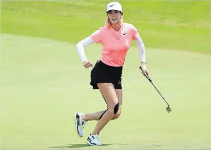  ?? ANDREW REDINGTON ?? GETTY IMAGES Michelle Wie of the United States celebrates her birdie on the 18th green during the final round of the HSBC Women's World Championsh­ip at Sentosa Golf Club on Sunday in Singapore.