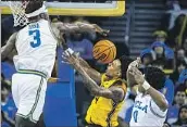  ?? Ringo H.W. Chiu Associated Press ?? UCLA CENTER ADEM BONA, left, easily blocks a shot by Arizona State’s Desmond Cambridge Jr.