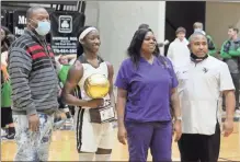  ?? Jeremy Stewart ?? Rockmart’s Keyarah Berry (second from left) poses with her parents and coach Andre Clark (right) after scoring her 3,000th point during Friday’s game at Rockmart High School.