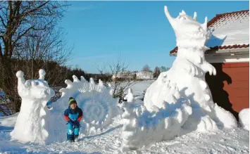  ??  ?? Jakob, 5, seine Schwester Sarah, 8, und Papa Thomas haben den schneereic­hen Winter in Waltenhofe­n genutzt, um eine Schnecke und einen großen Dino zu bauen.