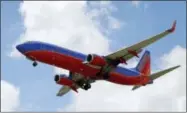  ?? TONY GUTIERREZ — THE ASSOCIATED PRESS FILE ?? In this file photo, a Southwest Airlines jet makes its approach to Dallas Love Field airport, in Dallas. Booking flights can be stressful as consumers worry about how to get the best deal and how far ahead to book, especially at holiday time. Experts...