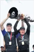  ?? PHOTO: GETTY IMAGES ?? Real deal . . . Peter Burling (left) and Glenn Ashby, of Emirates Team New Zealand, hold the America’s Cup aloft in Bermuda yesterday.