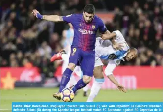  ??  ?? BARCELONA: Barcelona’s Uruguayan forward Luis Suarez (L) vies with Deportivo La Coruna’s Brazilian defender Sidnei (R) during the Spanish league football match FC Barcelona against RC Deportivo de la Coruna at the Camp Nou stadium in Barcelona.— AFP