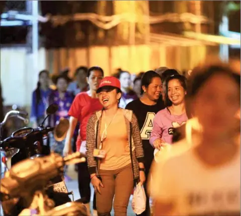  ?? HONG MENEA ?? Workers walk out of a garment factory yesterday evening in Phnom Penh’s Meanchey district, hours after the Labour Advisory Committee set next year’s minimum wage at $170 a month, the highest increase in the past two years.