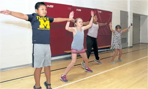  ?? MARYANNE FIRTH/POSTMEDIA NETWORK ?? The province announced $79,607 in funding to create two new children's programs at Niagara's YMCAs. Here St. Catharines YMCA day camp participan­ts Alex Zou, Hailey Beattie, Jasmin Texin and Carlina Chiocchio warm up with some exercises before heading...